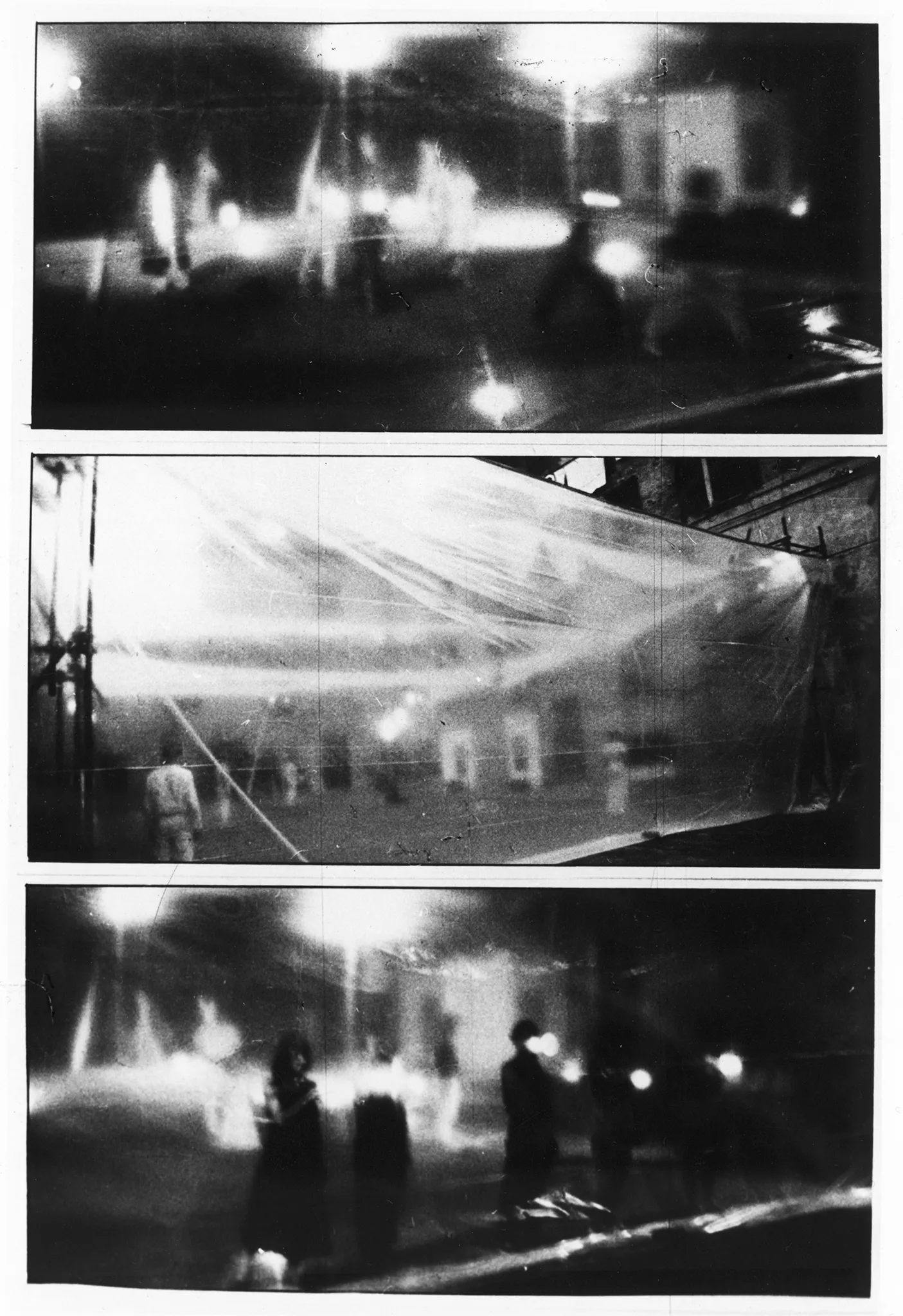 Trzy zdjęcia jedno pod drugim. Zdjęcie na górze przedstawia ledwo widocznych aktorów i reflektorów stojących za przeźroczystą płachtą. Zdjęcie w środku przedstawia przeźroczystą płachtę zawieszoną między budynkami. Za płachtą statycznie stoi grupa aktorów i aktorek. Zdjęcie na dole przedstawia grupę aktorów i aktorek stojących w szeregu za przeźroczystą płachtą. Trzymają w rękach latarki.